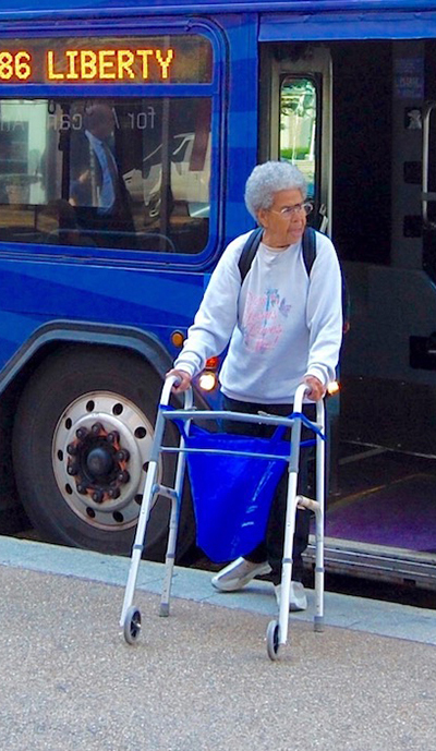 Woman with walker exiting a public transportation bus