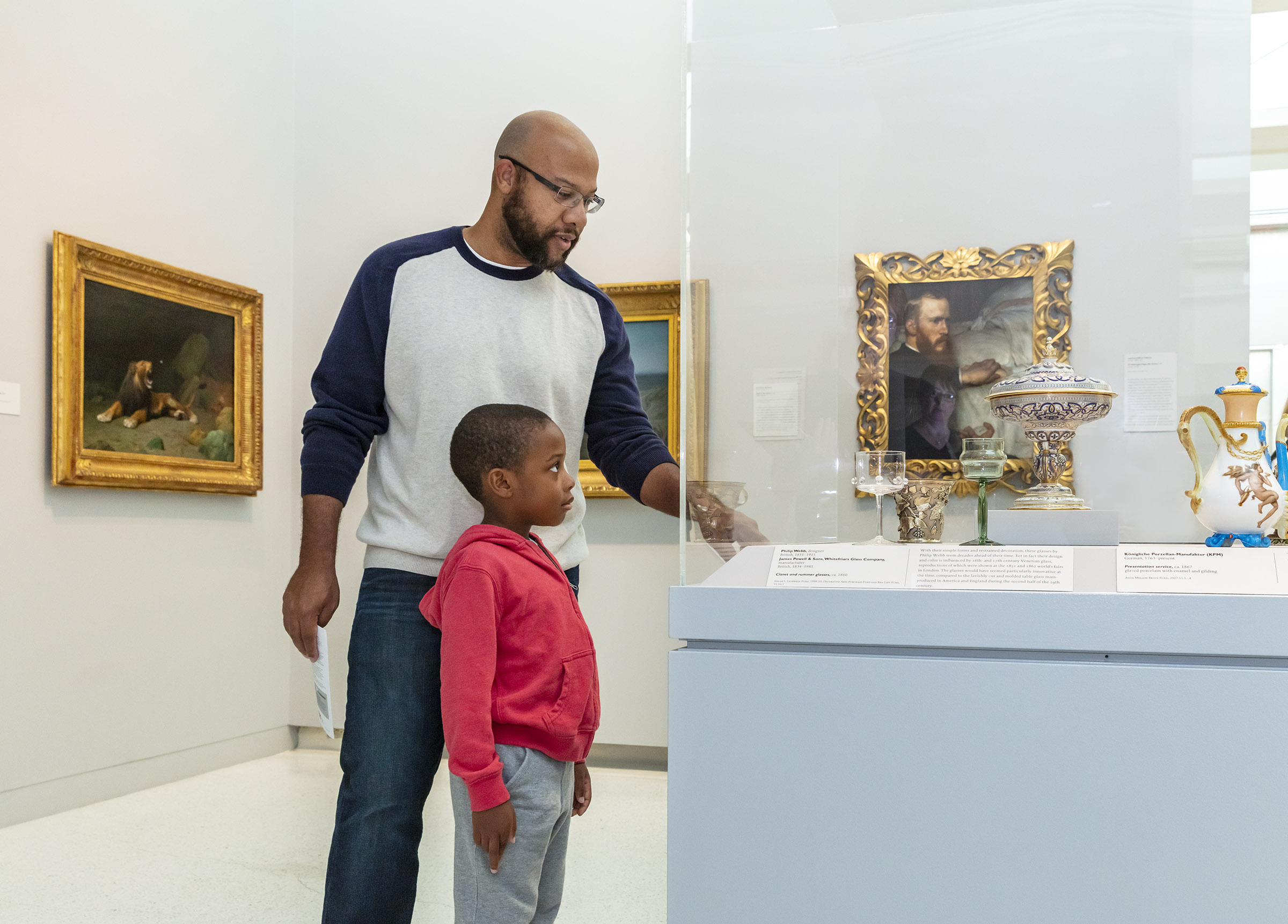 Farther and son stand in front of museum display.