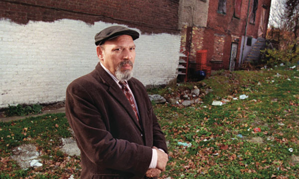 Playwright August Wilson standing in front of his childhood home