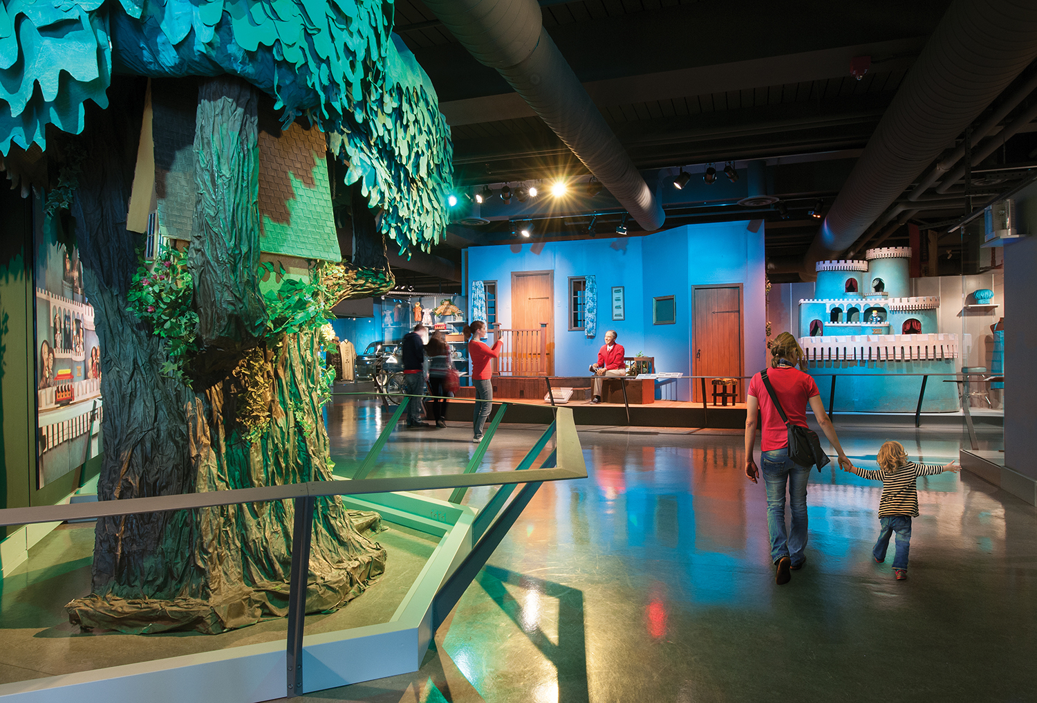 An art exhibit with a large tree display.