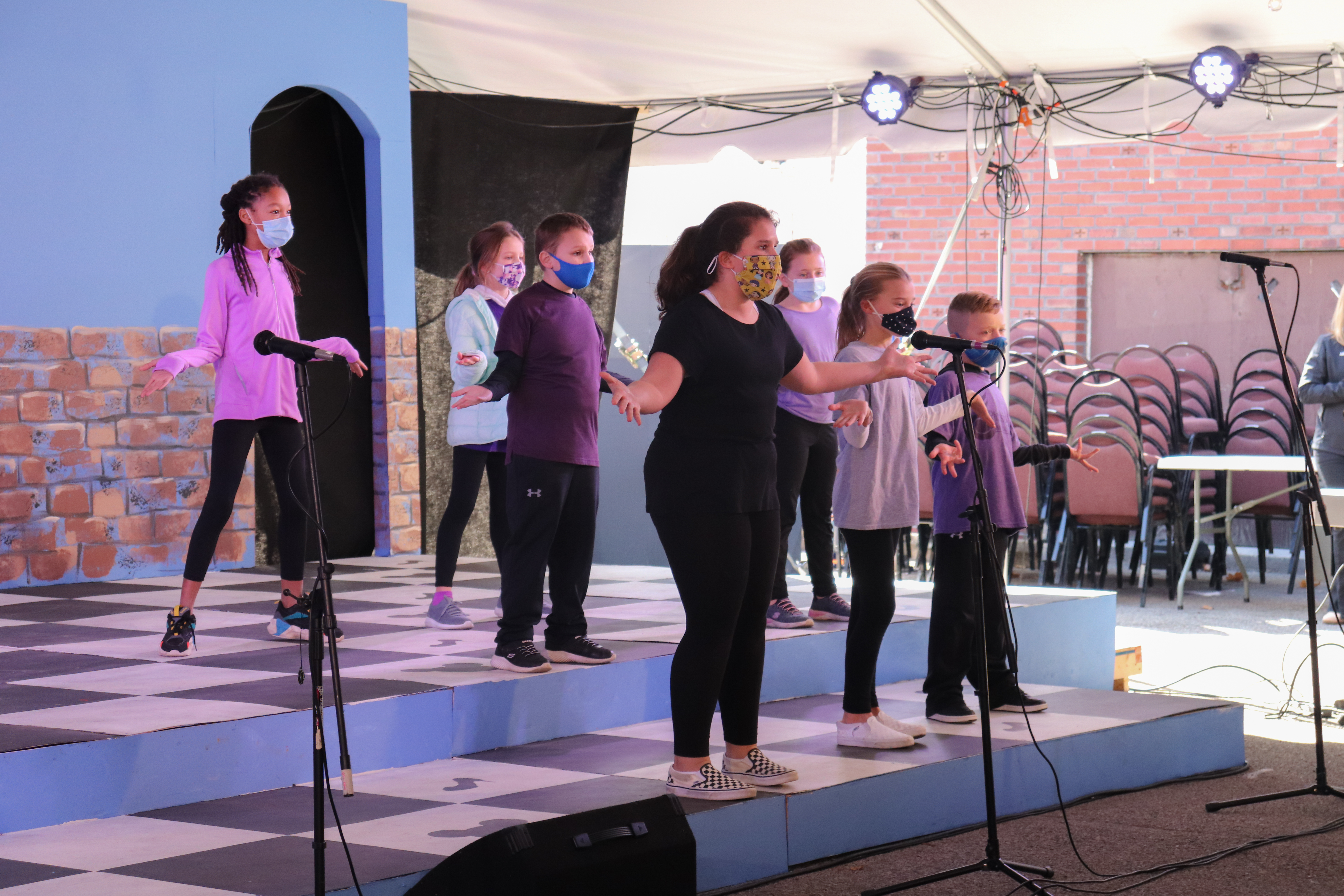 Children performing on a stage.