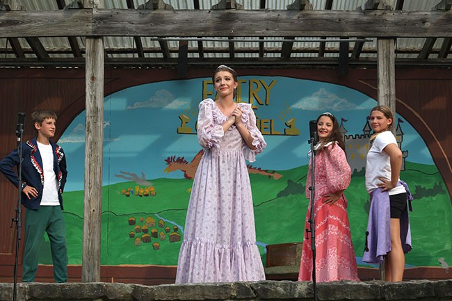 Performers on a outdoor stage.
