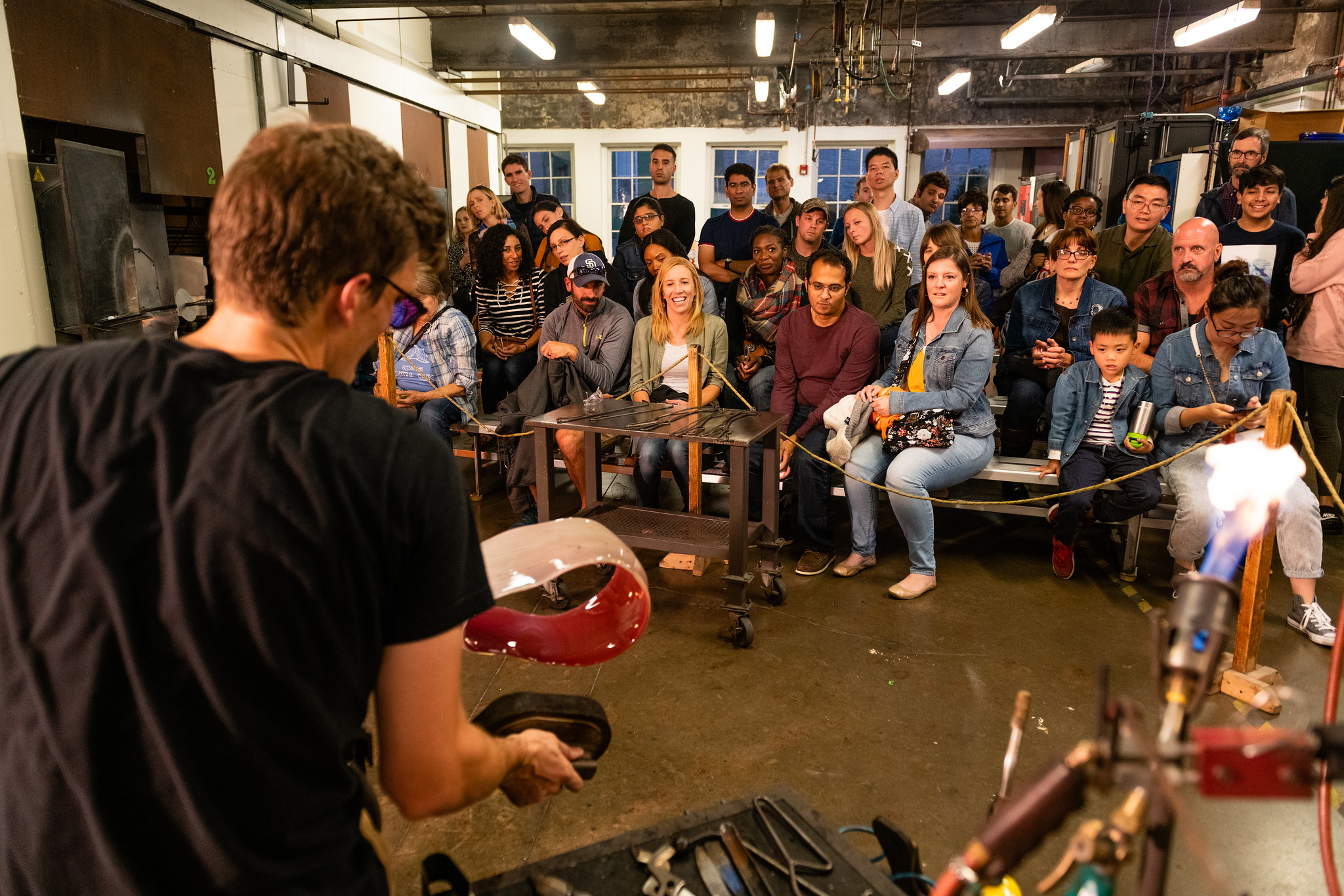 Performer in front of a seated crowd.