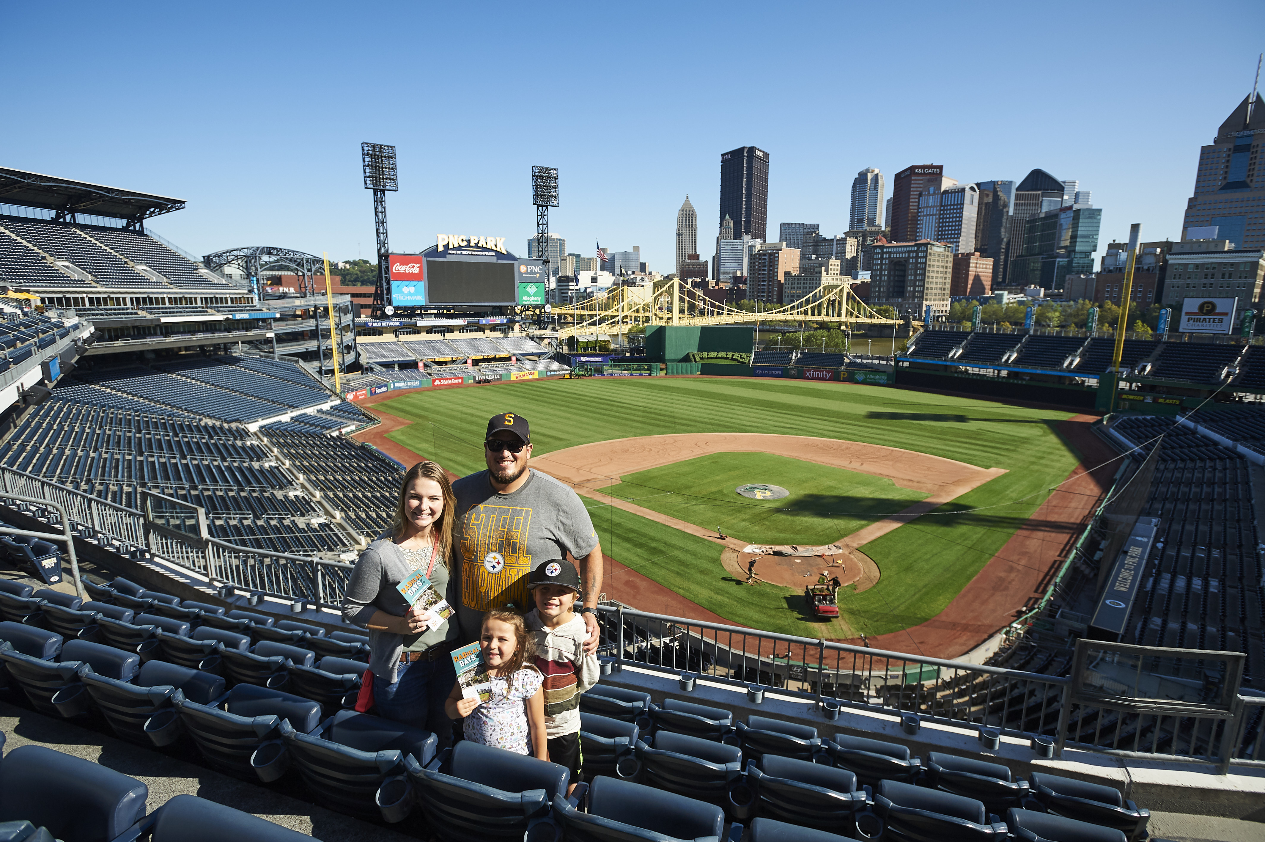 Family standing with PNC Park in the background