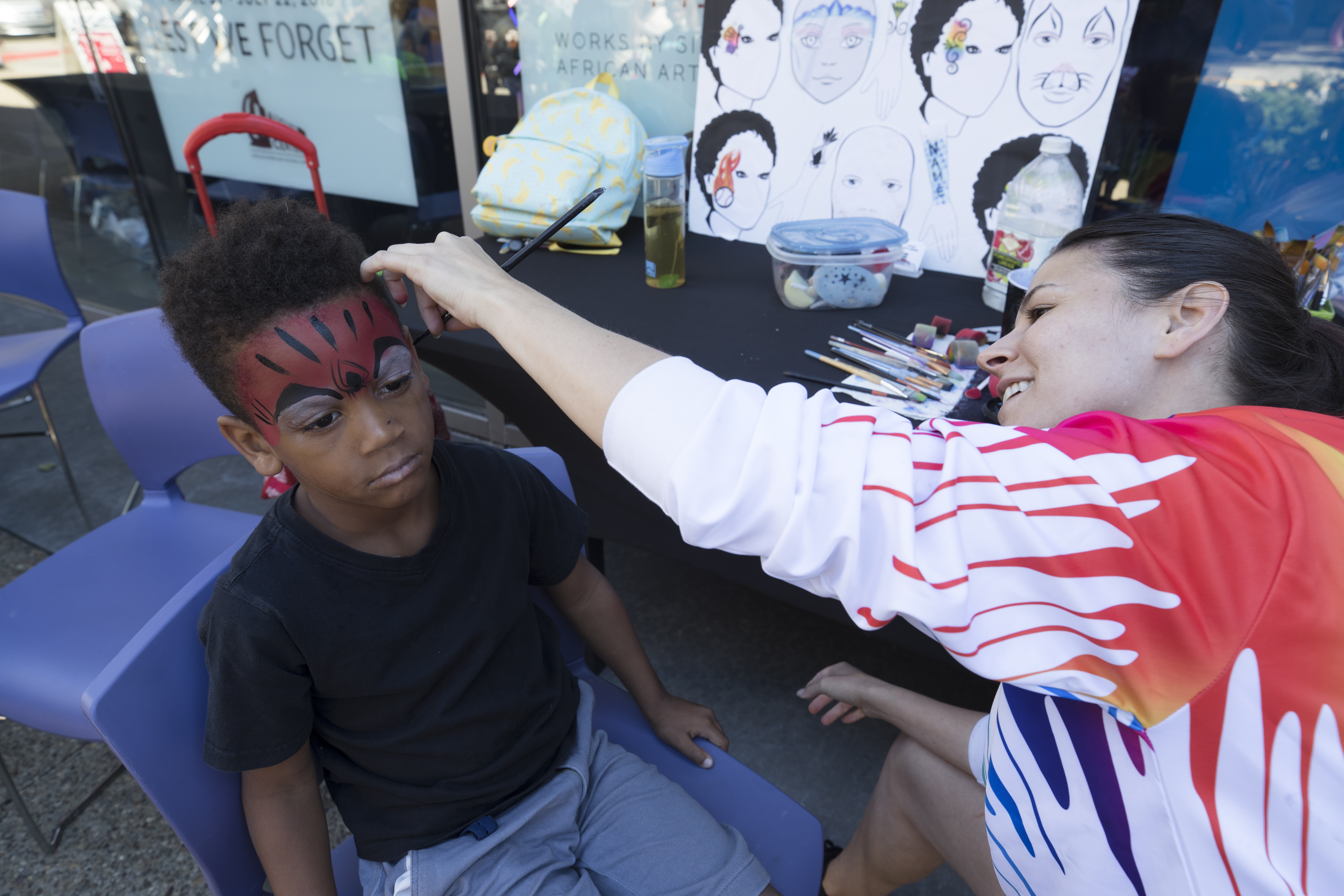 A little boy getting his face painted at August Wilson African American Cultural Center's Community Day.