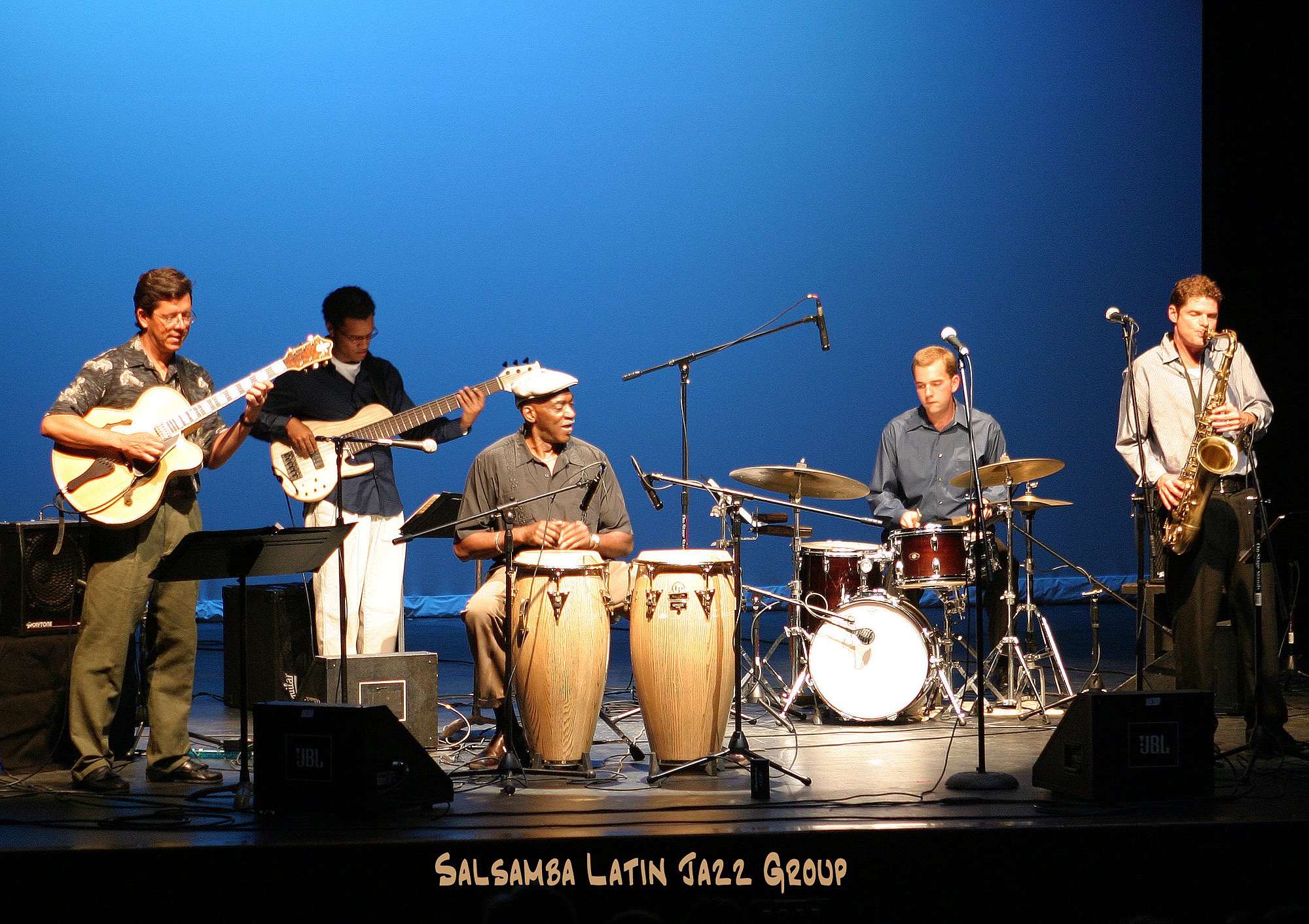 Musicians from Salsamba playing onstage.