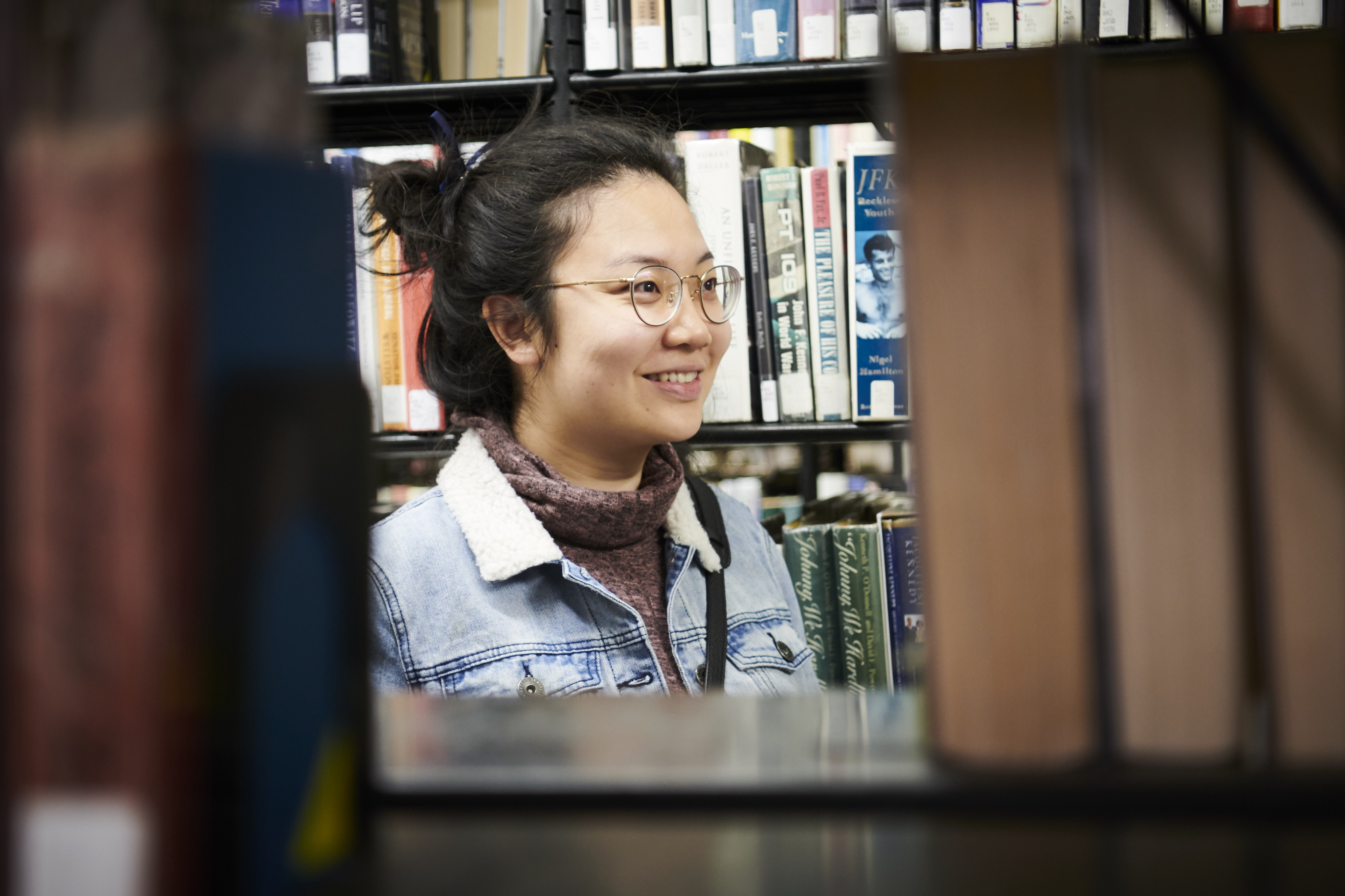 Woman in stacks of library books