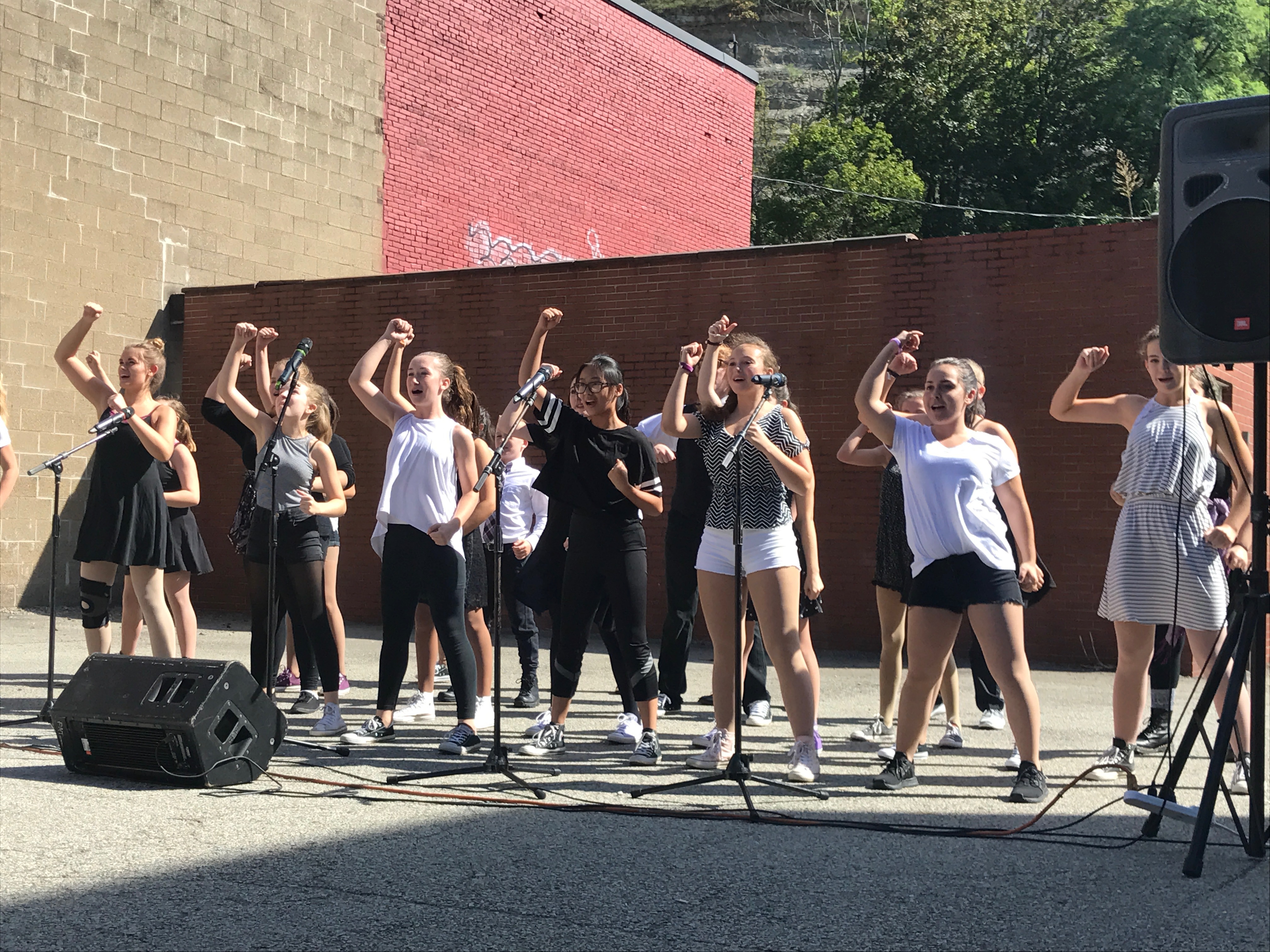 Kids and teens performing on an outdoor stage