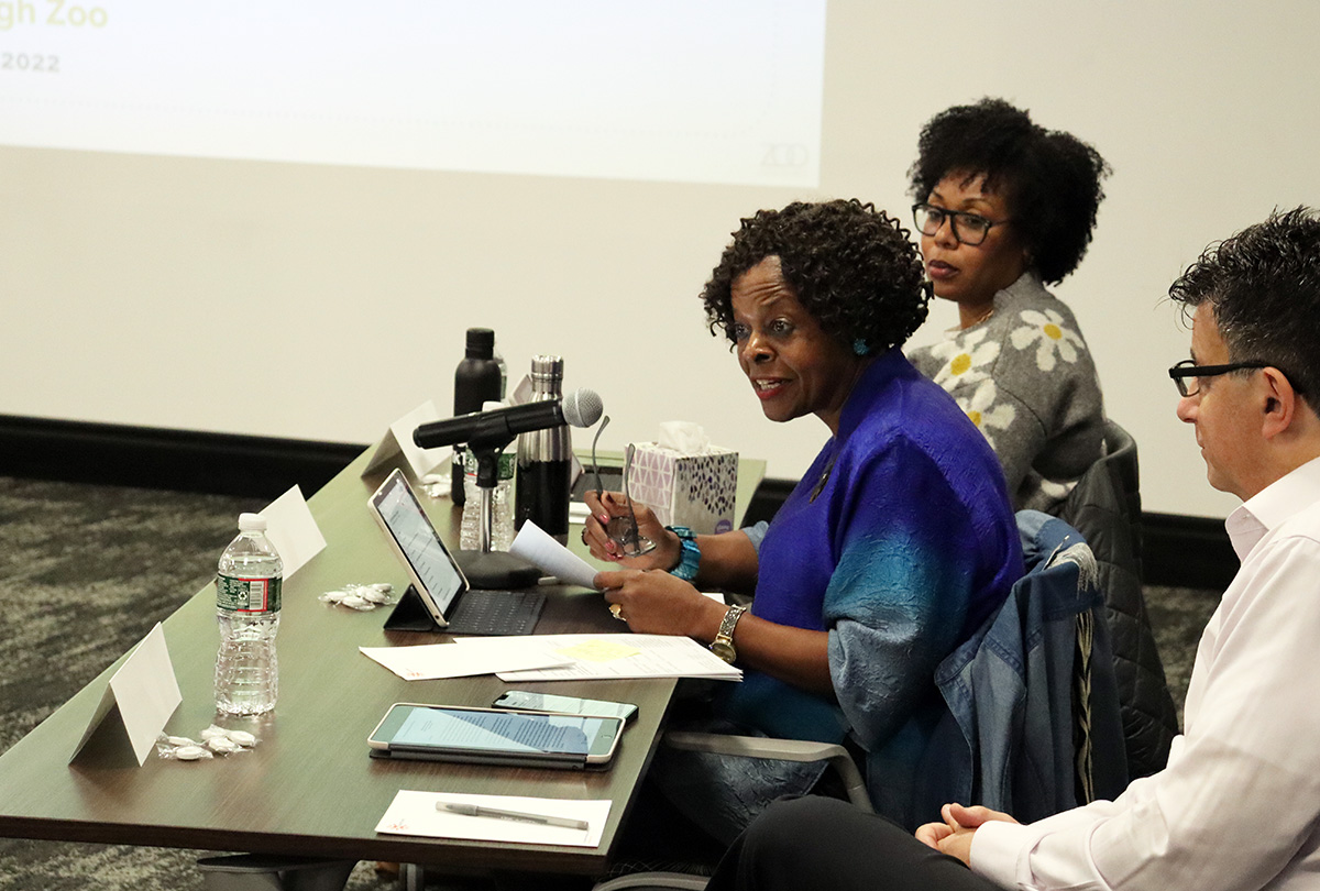 RAD Board member Jackie Dixon reads the Allocations Committee report, flanked by fellow Board members Kendra Ross, PhD and Daniel Rosen, PhD
