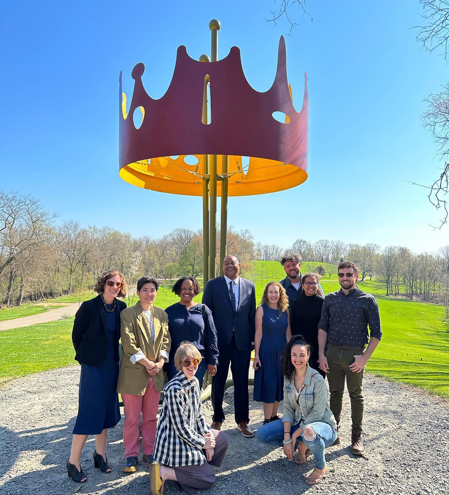 Group photo in front of sculpture including Pittsburgh Mayor Ed Gainey