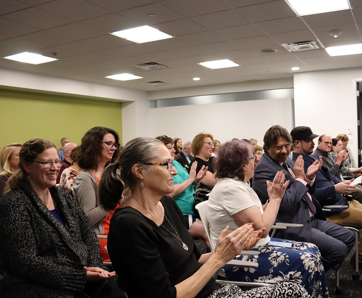 Audience in board meeting applauding