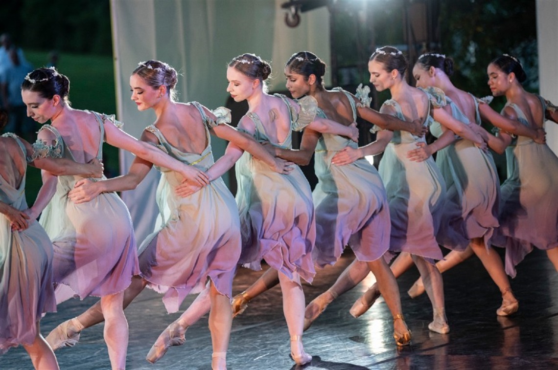 Photograph of several ballet performers on stage