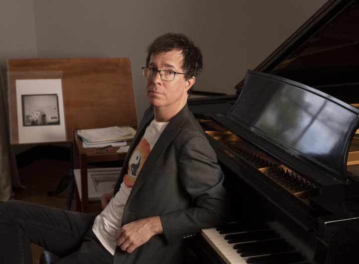Photograph of Ben Folds sitting at a piano