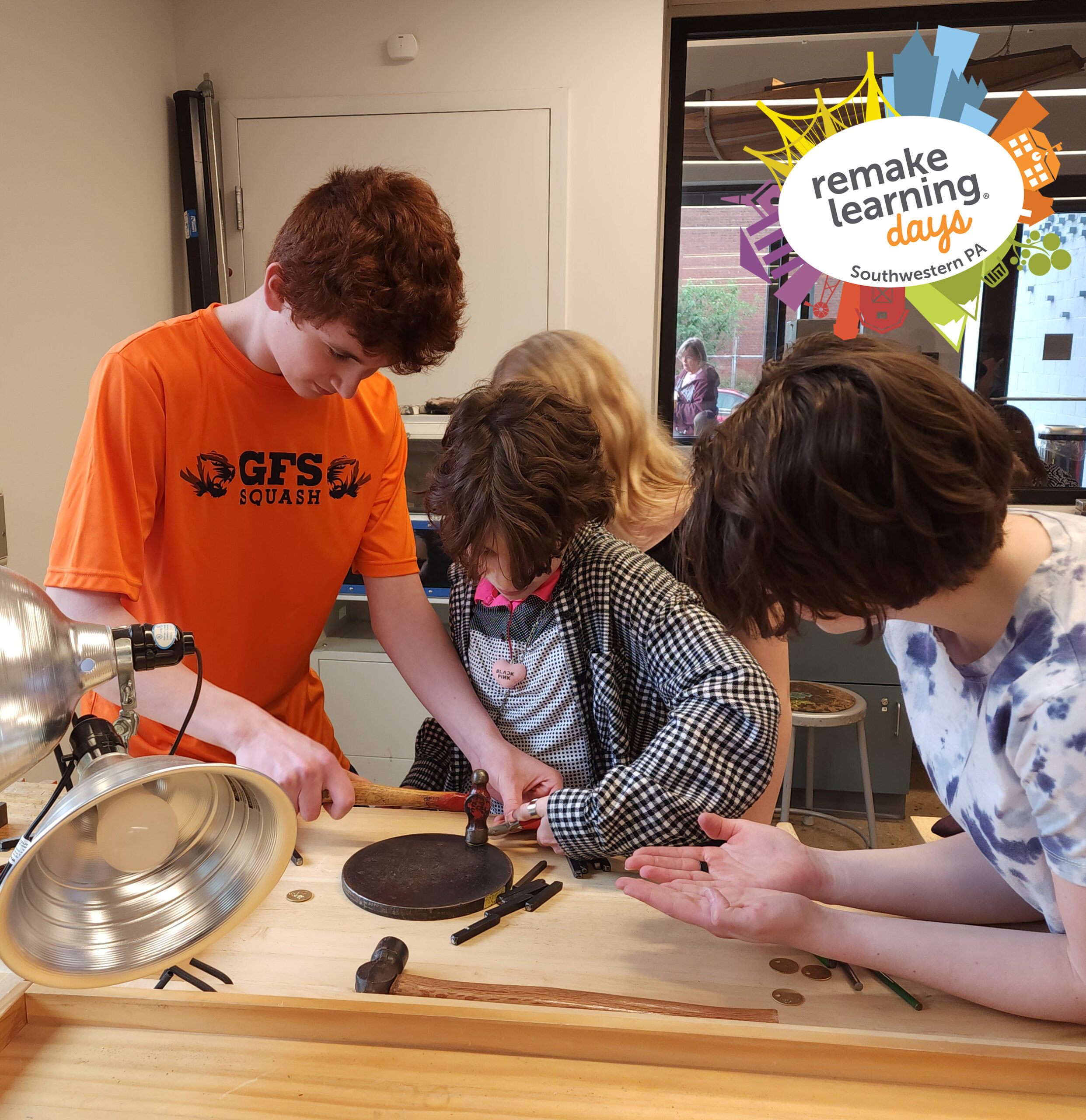 Photograph of three children doing metalwork at a table