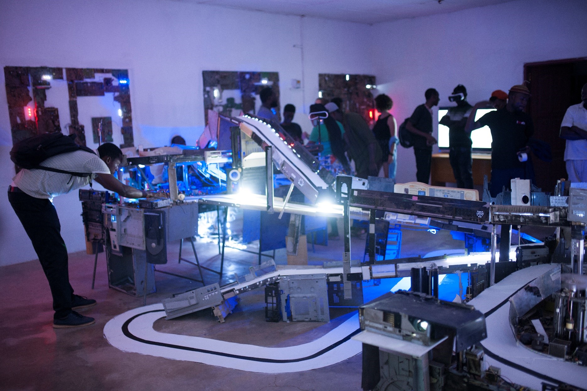 Photograph of patrons gathered around an Akwasi Afrane installation