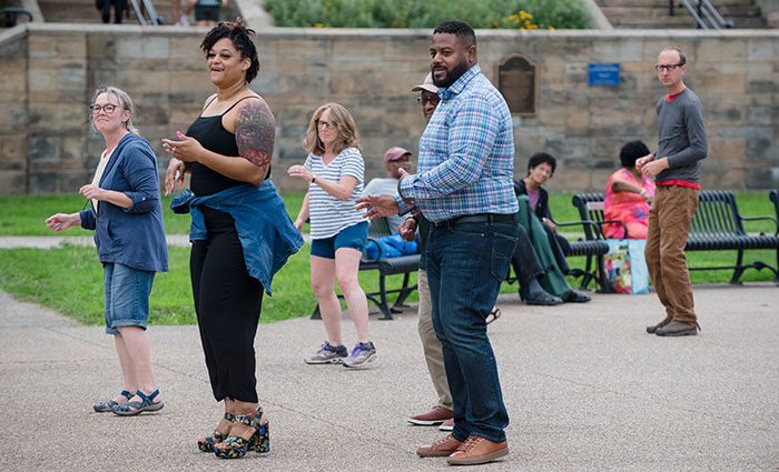 Photograph of a group of people line dancing