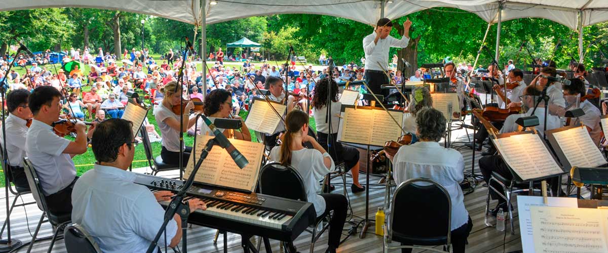 Photograph of an orchestra under a tent