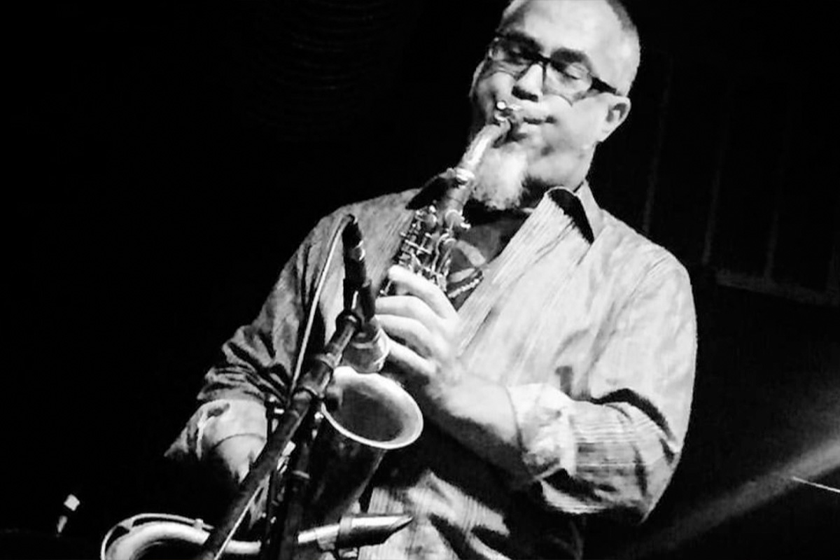 Black and white photo of Erik Lawrence playing saxophone
