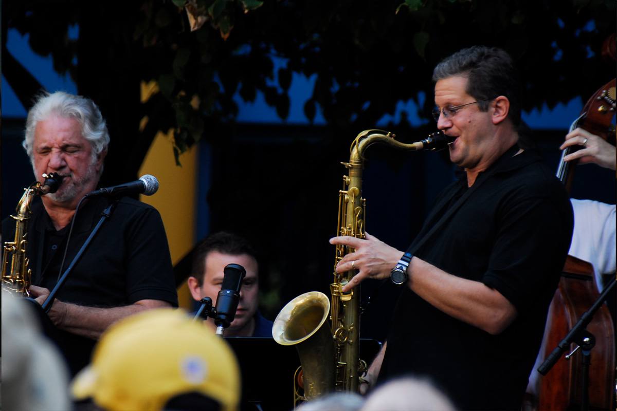Photograph of a father and son playing saxophones