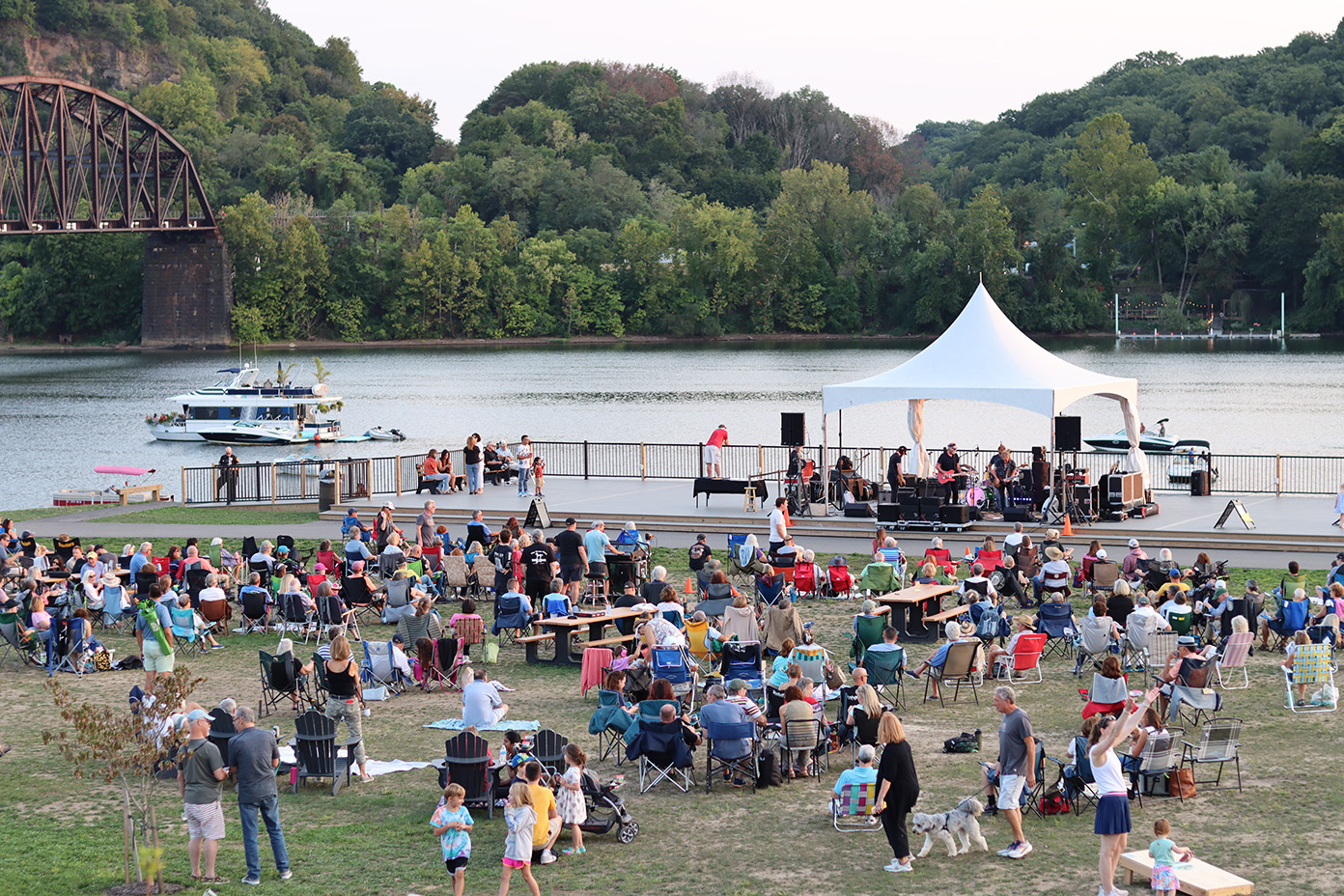 People sitting in lawn chairs watching an outdoor concert