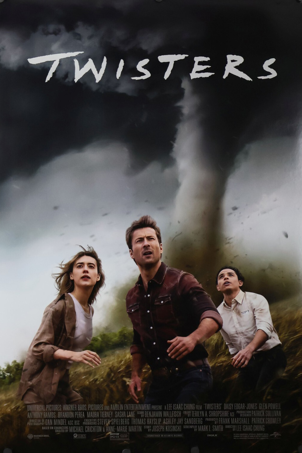 Movie poster for Twisters with three people in front of a tornado