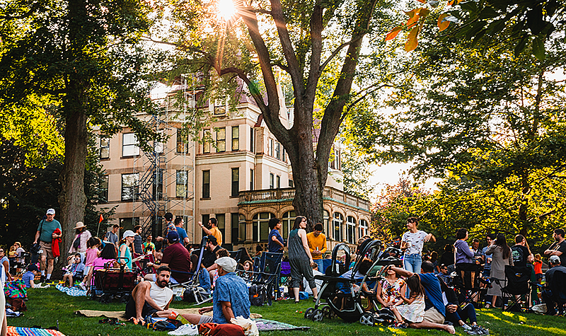 People relaxing on the lawn in front of historic Clayton at The Frick Pittsburgh